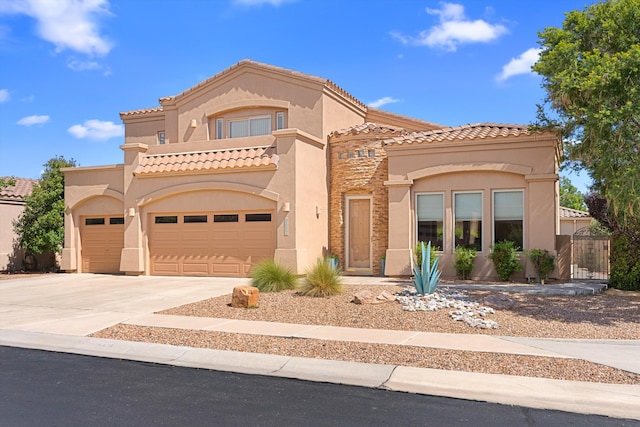 mediterranean / spanish home with a garage