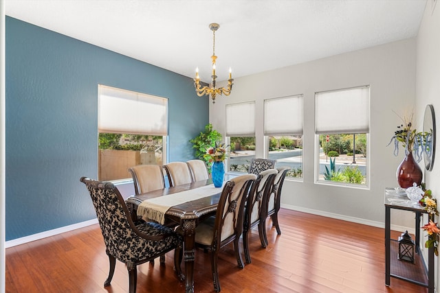 dining room with an inviting chandelier and wood-type flooring