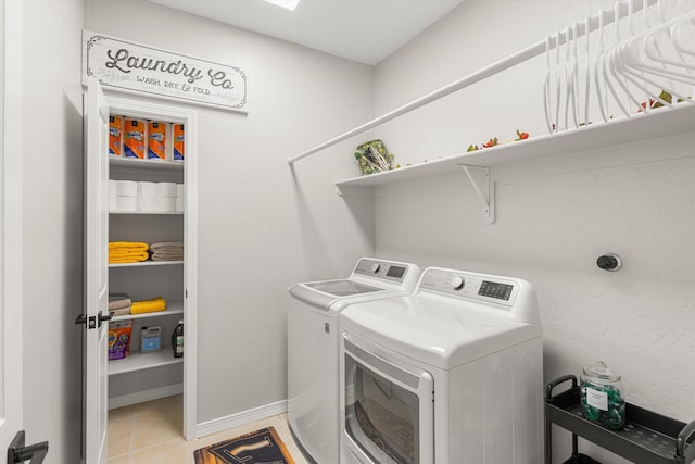 washroom with light tile patterned flooring and washer and clothes dryer