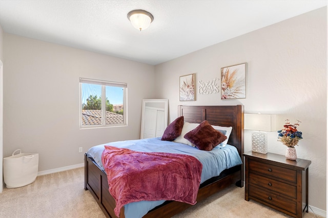 bedroom featuring light carpet