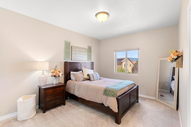 carpeted bedroom featuring a textured ceiling