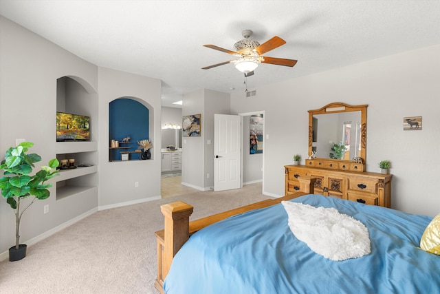 carpeted bedroom featuring connected bathroom and a textured ceiling