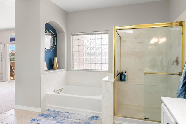 bathroom with vanity, plenty of natural light, tile patterned floors, and separate shower and tub