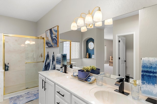 bathroom with tile patterned flooring, vanity, and a shower with shower door