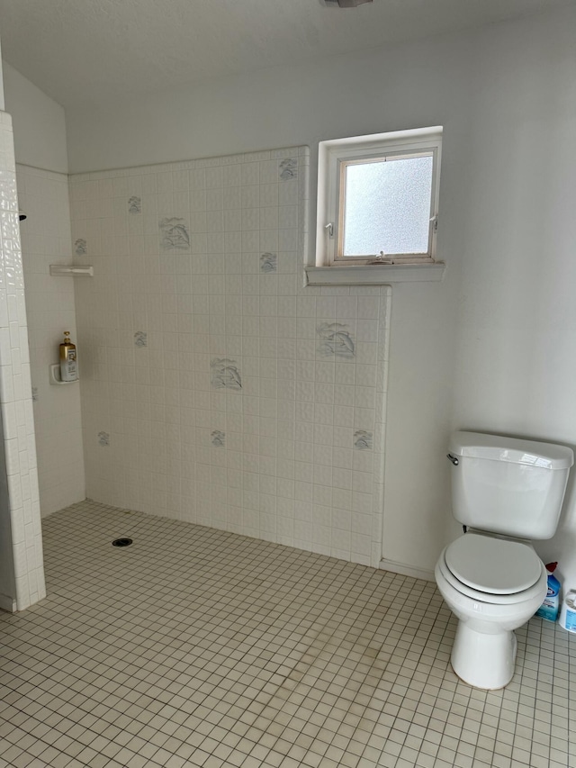 bathroom with toilet and tile patterned flooring