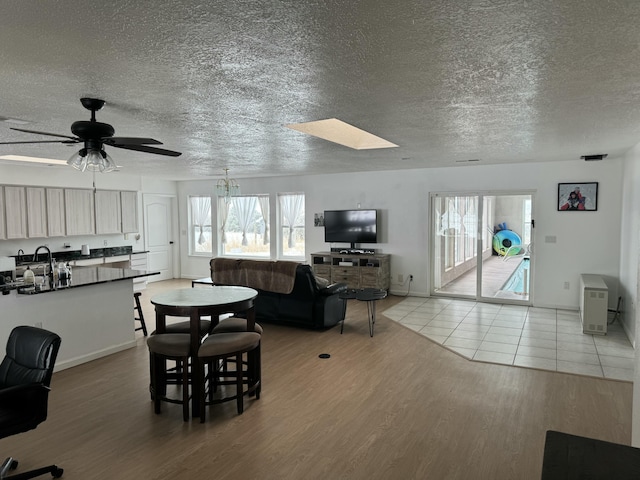 dining room featuring sink, light hardwood / wood-style floors, and ceiling fan