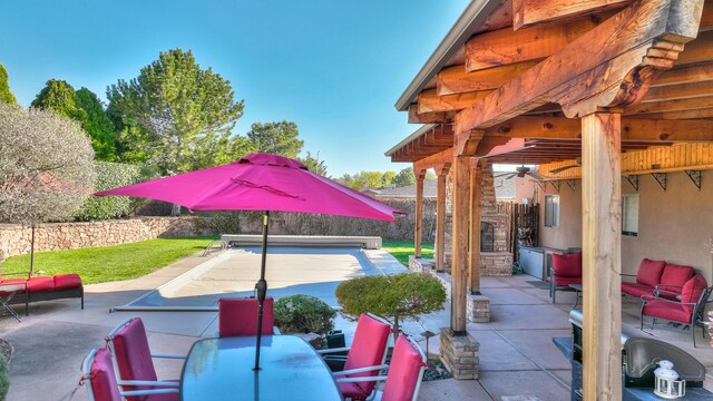 view of patio / terrace with ceiling fan and an outdoor living space