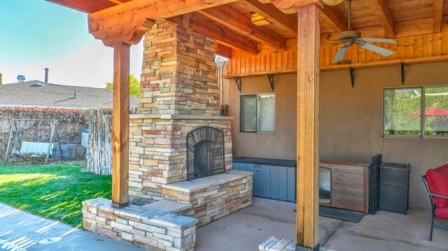 view of patio / terrace with ceiling fan and an outdoor stone fireplace