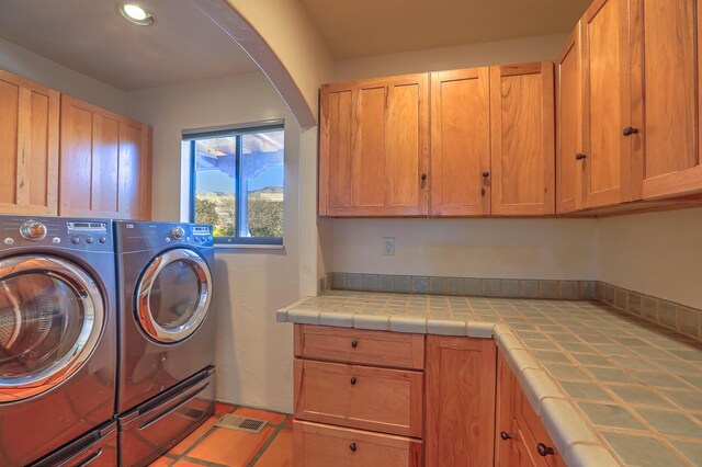 laundry room with cabinets and separate washer and dryer