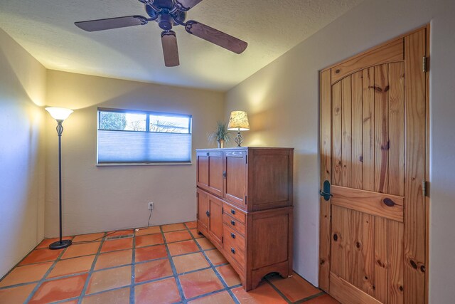 interior space with ceiling fan and tile patterned floors