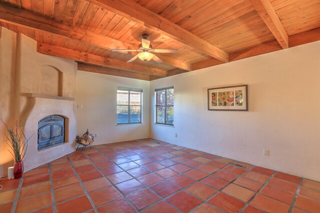 unfurnished living room featuring ceiling fan, wooden ceiling, beam ceiling, and tile patterned flooring