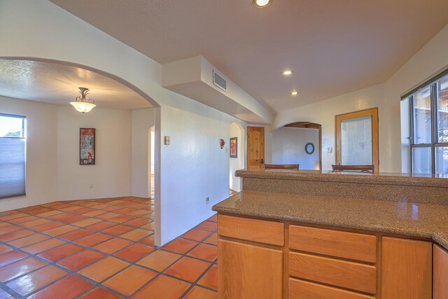 kitchen with hanging light fixtures and tile patterned floors