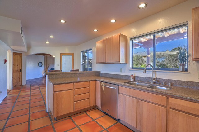 kitchen featuring stainless steel dishwasher, kitchen peninsula, sink, and tile patterned flooring