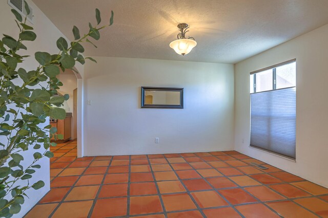 spare room with a textured ceiling