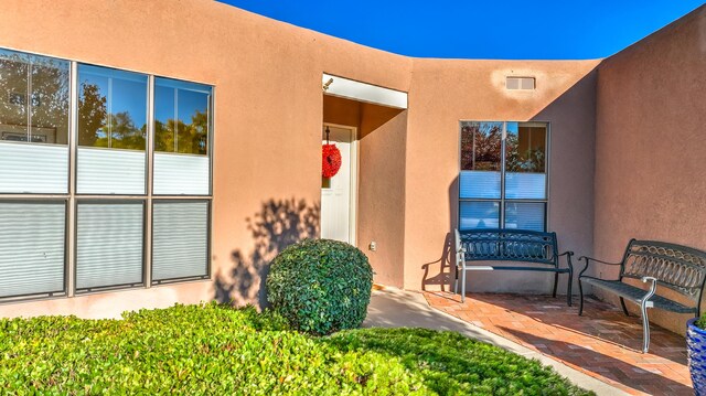 doorway to property with a patio area