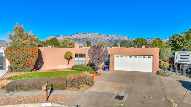 view of front facade featuring a garage and a mountain view