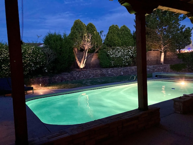 view of pool at dusk