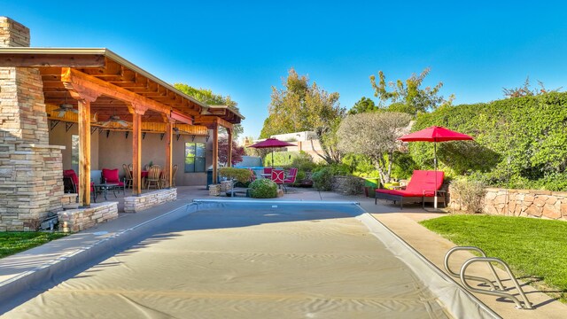 view of pool featuring a patio area and ceiling fan