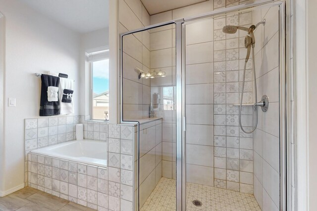 bathroom with shower with separate bathtub