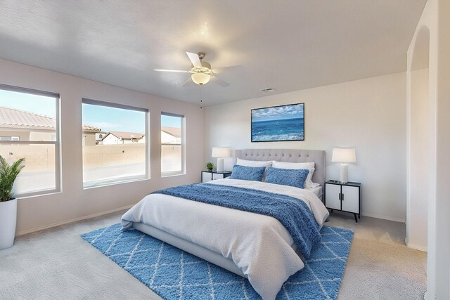 bedroom with light colored carpet and ceiling fan