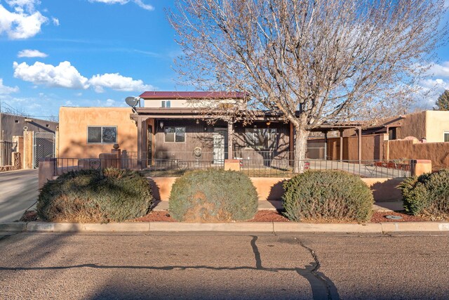 view of front facade with a front lawn and a carport