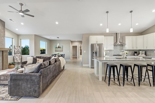 living room featuring ceiling fan and lofted ceiling