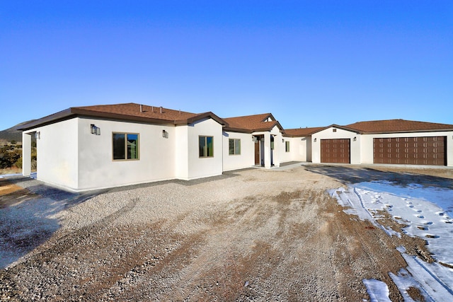 view of front of house featuring an attached garage and stucco siding