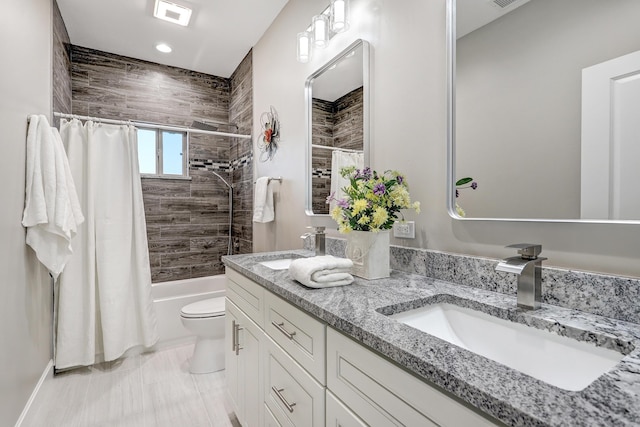 full bathroom featuring toilet, shower / tub combo, and vanity