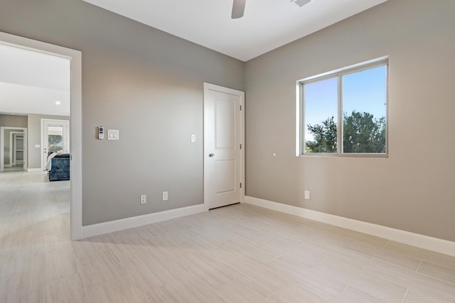 spare room featuring ceiling fan and plenty of natural light