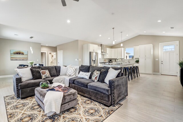 living room with ceiling fan and lofted ceiling