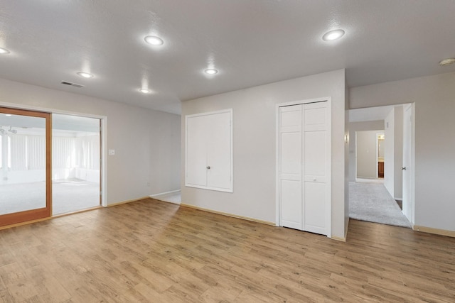 spare room featuring light hardwood / wood-style flooring