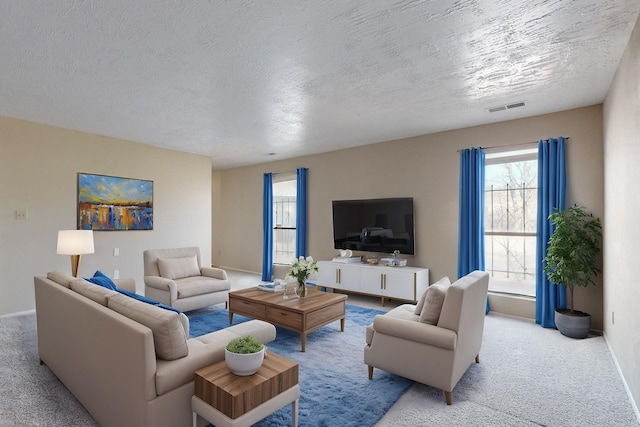 living room with a wealth of natural light, a textured ceiling, and light carpet