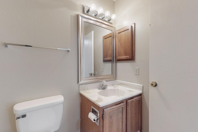 bathroom with toilet and vanity