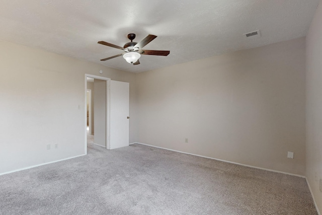 carpeted spare room with a textured ceiling