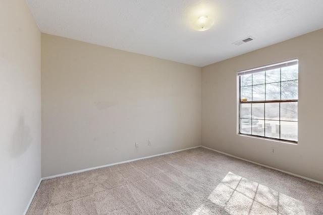 unfurnished room with light carpet