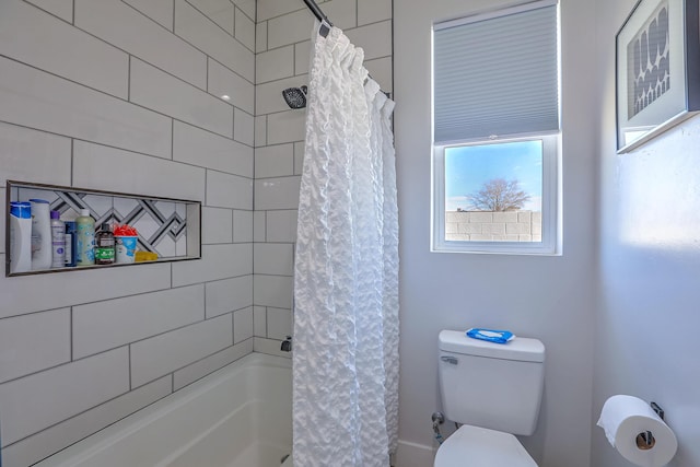 bathroom featuring toilet and shower / tub combo with curtain