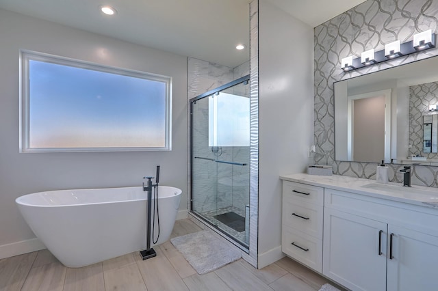 bathroom with vanity, plenty of natural light, and independent shower and bath