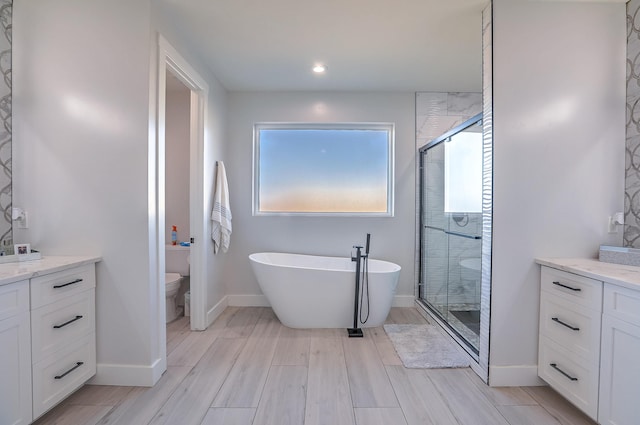 full bathroom featuring separate shower and tub, vanity, and toilet