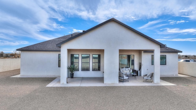 back of house with a patio