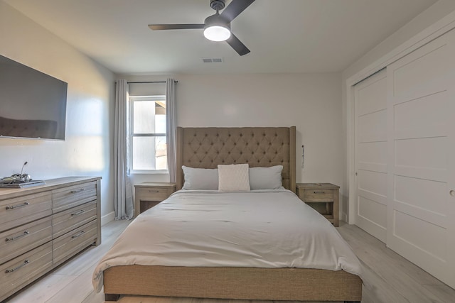 bedroom with ceiling fan, a closet, and light wood-type flooring