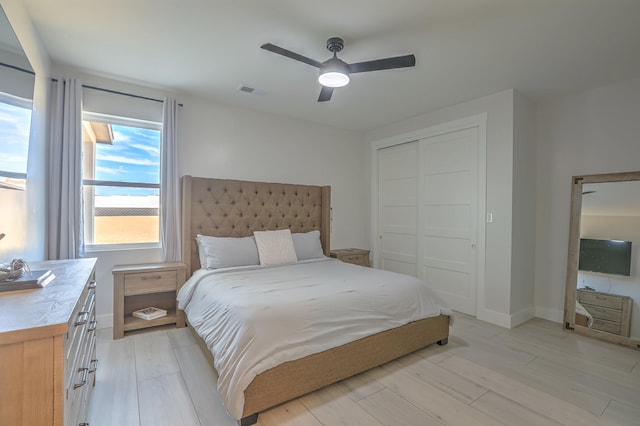 bedroom featuring ceiling fan, a closet, and light hardwood / wood-style floors