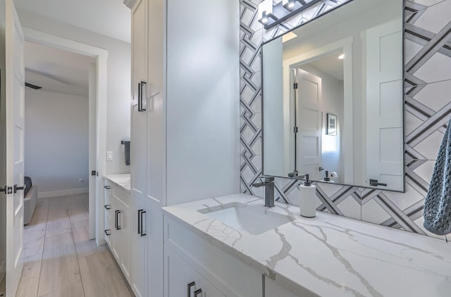 bathroom featuring hardwood / wood-style flooring and vanity