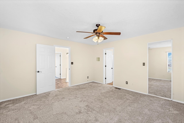 spare room with light carpet and ceiling fan