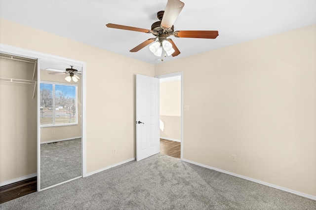 unfurnished bedroom with ceiling fan, carpet, and a closet