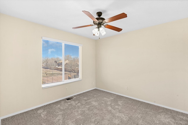 unfurnished room with ceiling fan and light carpet