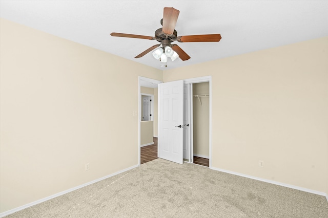 unfurnished bedroom with ceiling fan, a closet, and carpet flooring