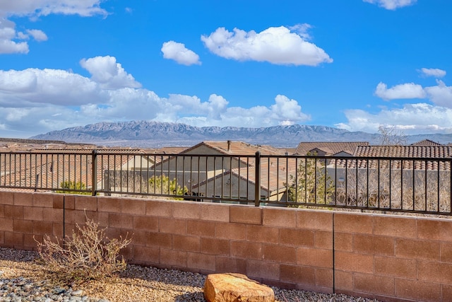 wooden terrace featuring fence and a mountain view