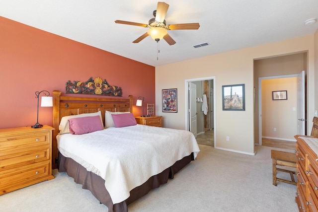 carpeted bedroom with ceiling fan and connected bathroom