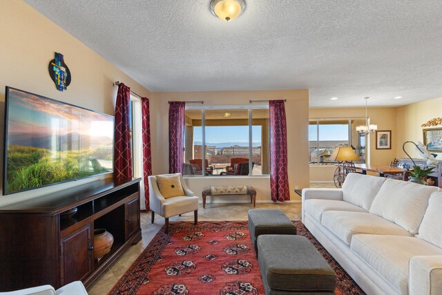 living room with a textured ceiling and a chandelier