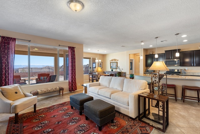 living room with light tile patterned floors, a notable chandelier, a textured ceiling, and recessed lighting